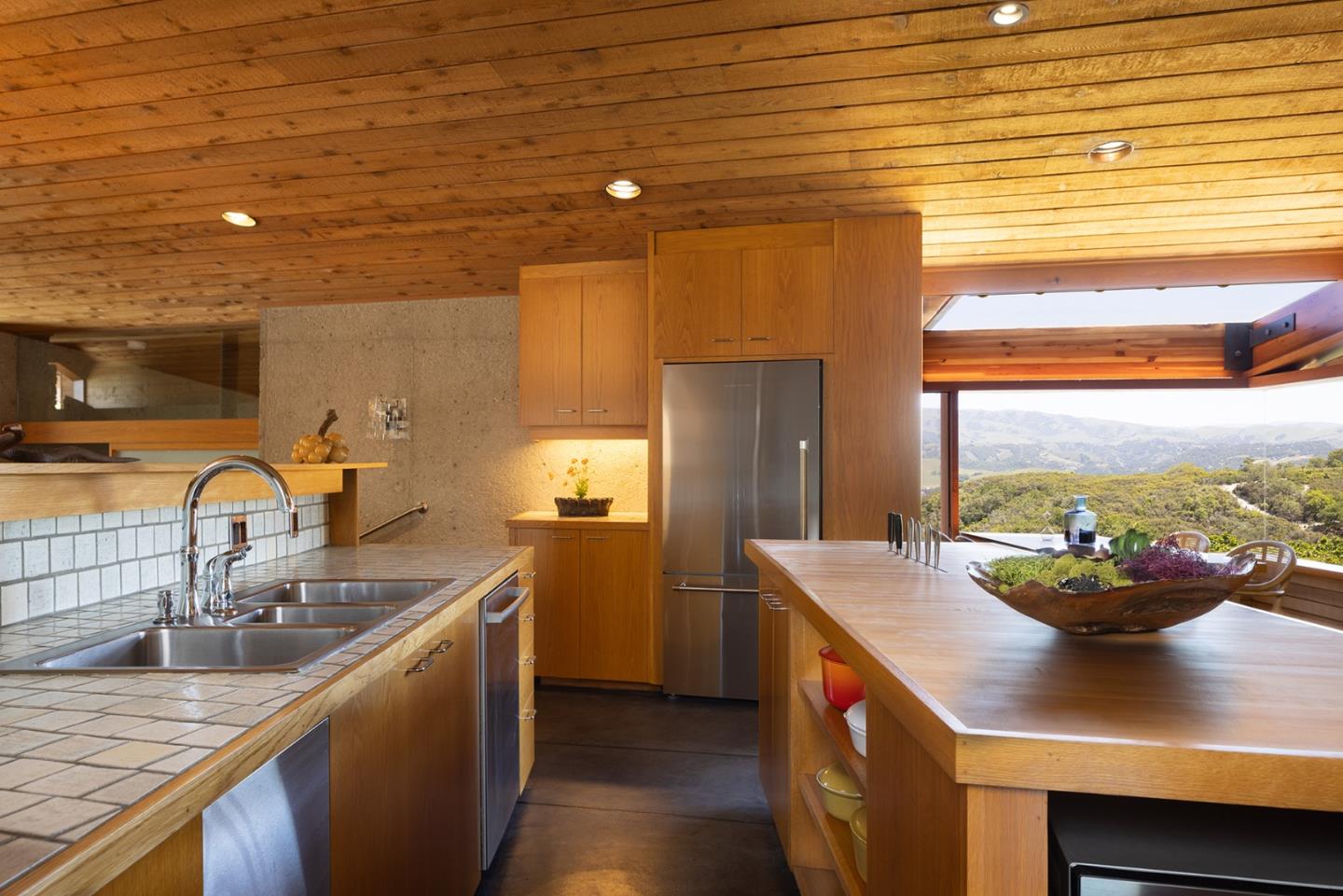 26225 Rinconada Drive Carmel Valley, CA 93924 - Photo 19 of 44 a kitchen with a sink and a refrigerator