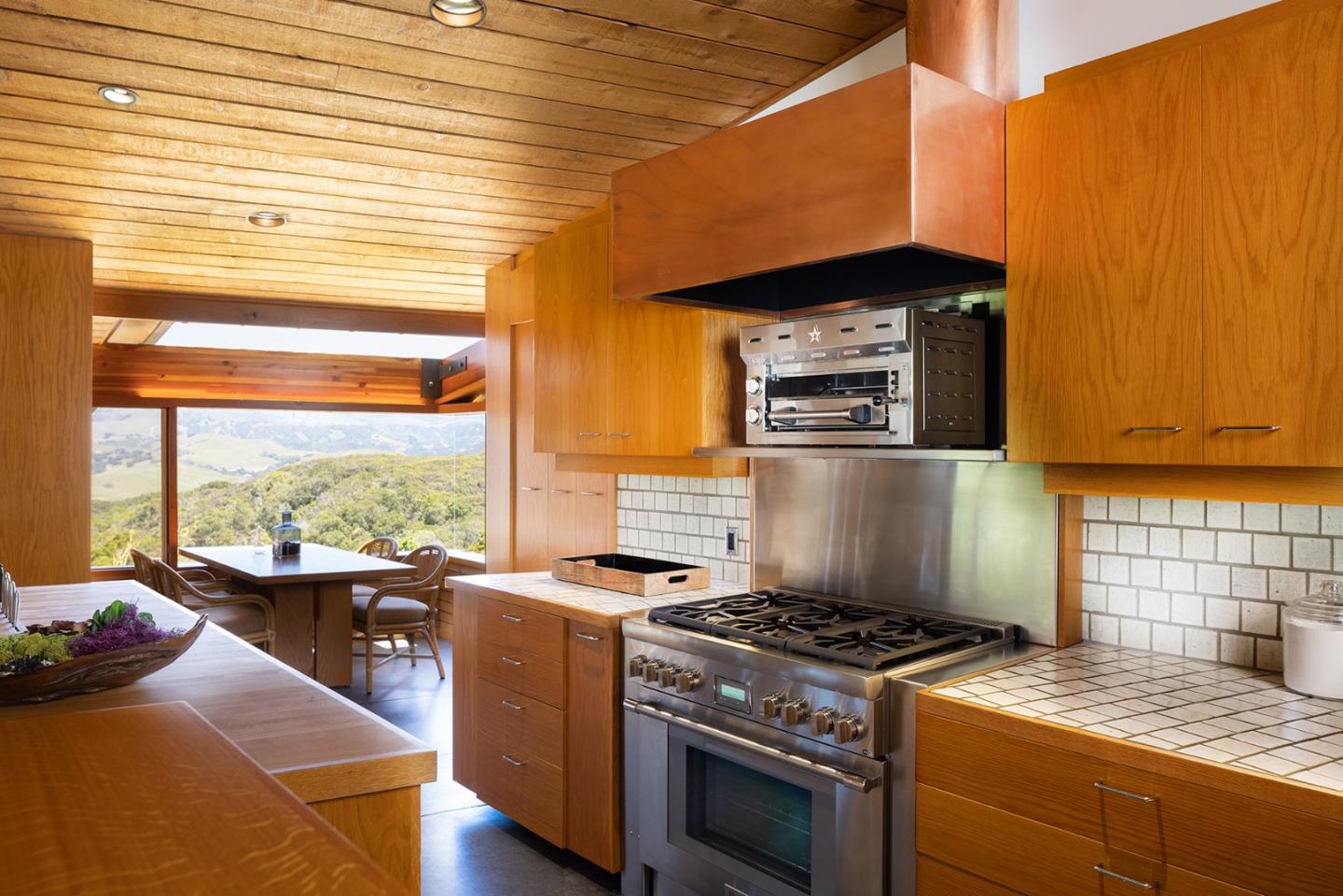 26225 Rinconada Drive Carmel Valley, CA 93924 - Photo 20 of 44 a kitchen with a stove a sink and a microwave