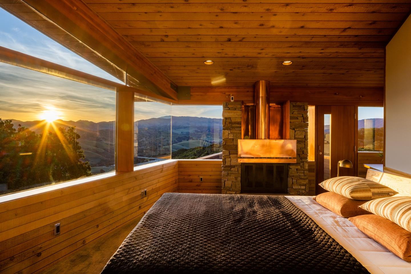 26225 Rinconada Drive Carmel Valley, CA 93924 - Photo 2 of 44 a bedroom with a large bed and a balcony view