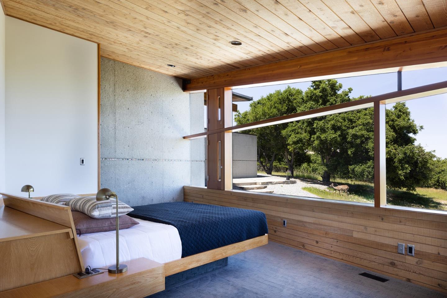 26225 Rinconada Drive Carmel Valley, CA 93924 - Photo 21 of 44 a bedroom with furniture and a window