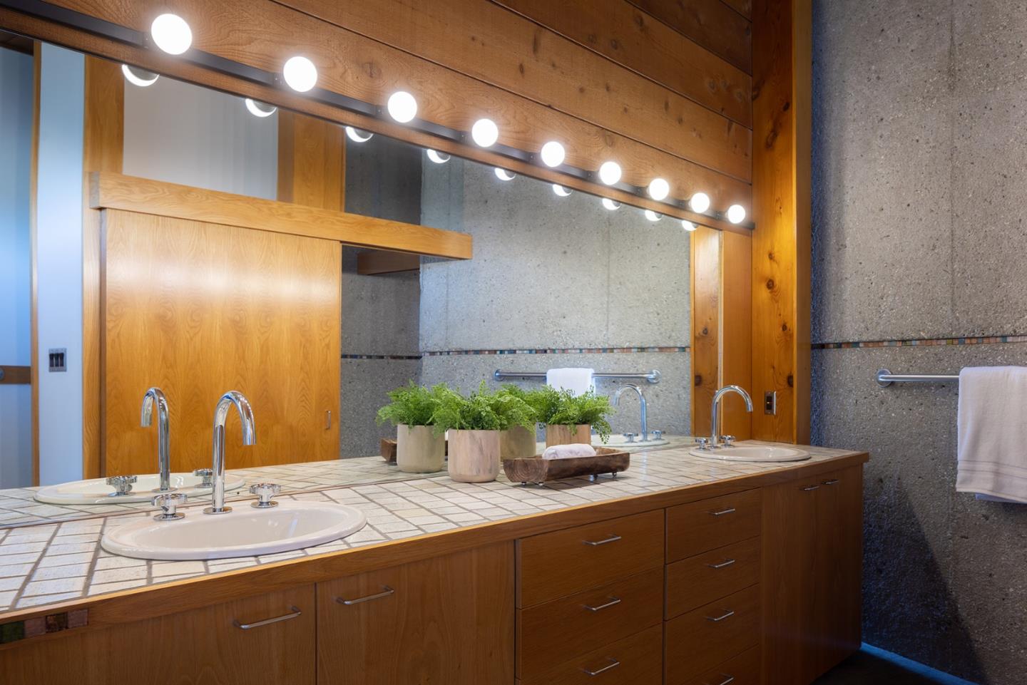 26225 Rinconada Drive Carmel Valley, CA 93924 - Photo 25 of 44 a bathroom with a sink and a mirror