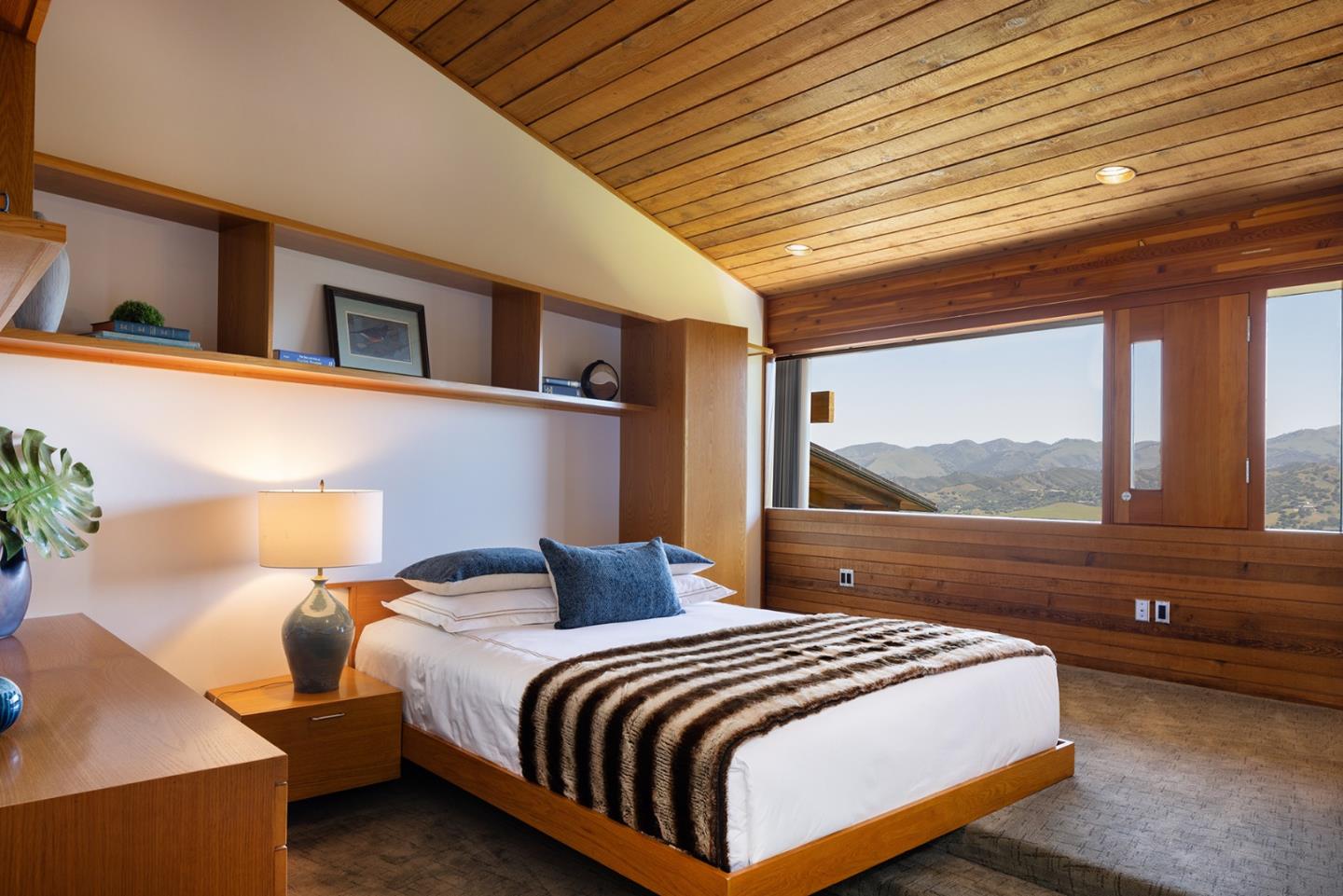 26225 Rinconada Drive Carmel Valley, CA 93924 - Photo 29 of 44 a bedroom with a large bed and a balcony view