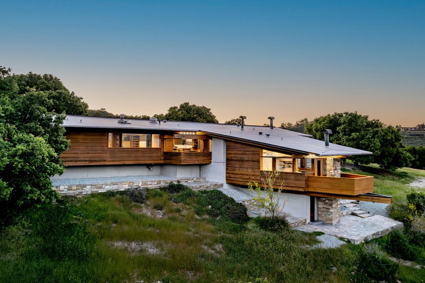 26225 Rinconada Drive Carmel Valley, CA 93924 - Photo 3 of 44 a view of a house with a big yard plants and large trees