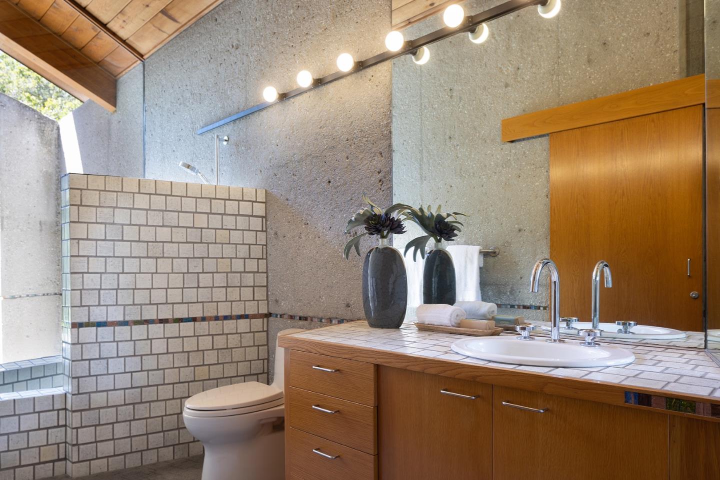 26225 Rinconada Drive Carmel Valley, CA 93924 - Photo 32 of 44 a bathroom with a sink a toilet and shower