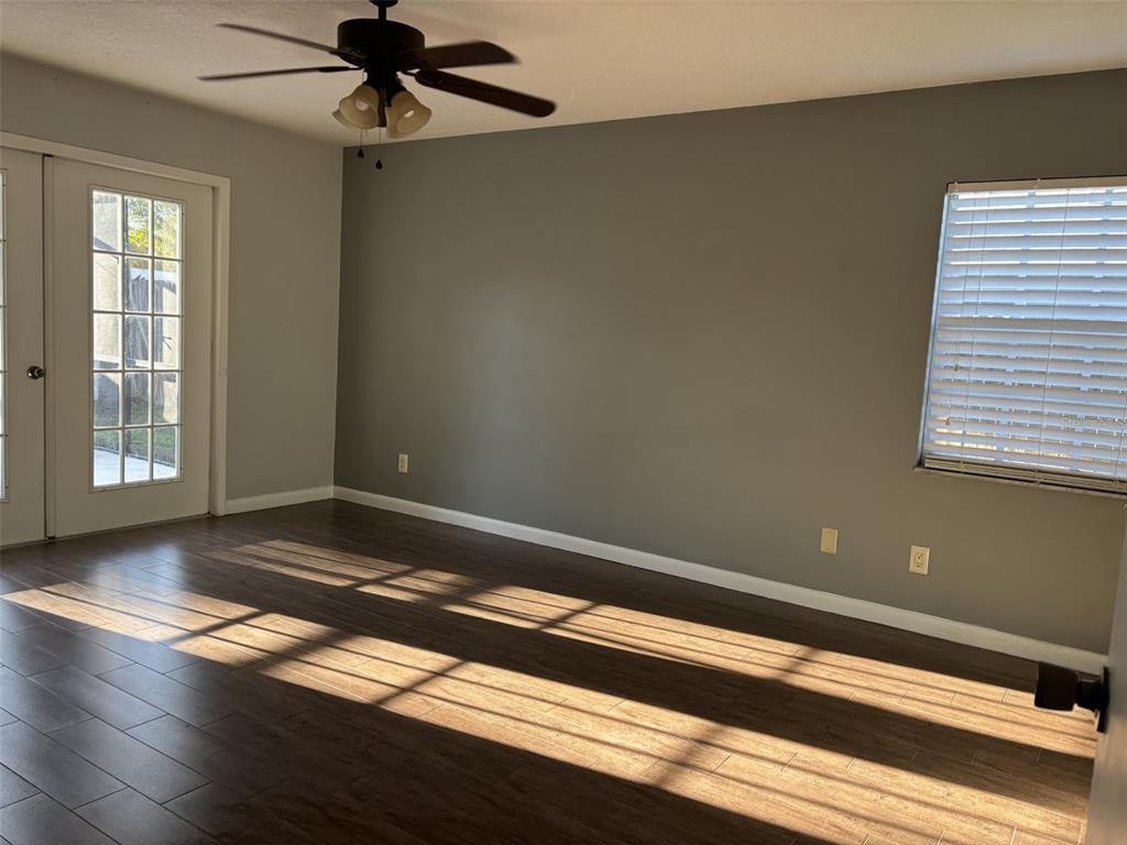 1927 Cheney Court Lutz, FL 33549 - Photo 12 of 20 a view of an empty room with wooden floor and a window