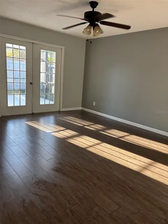 wooden floor in an empty room with a window