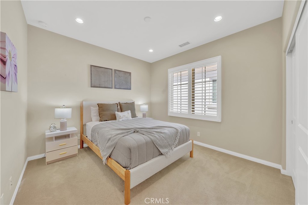 75 Gardenstone Path Irvine, CA 92620 - Photo 32 of 65 a spacious bedroom with a bed and a window