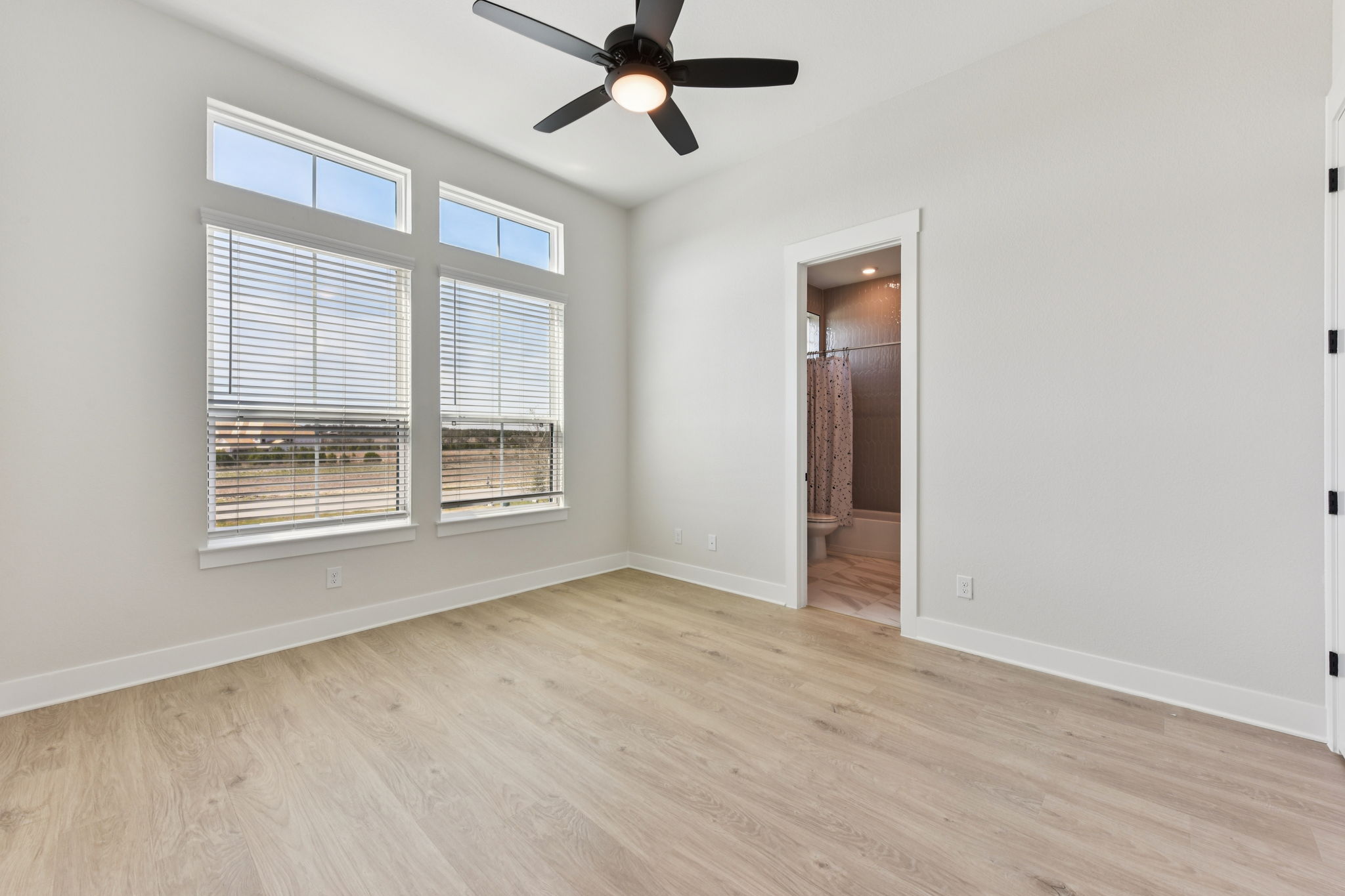 1400 Paxton Lane Georgetown, TX 78633 - Photo 17 of 39 Unfurnished bedroom featuring light wood-style floors, a ceiling fan, and ensuite bathroom