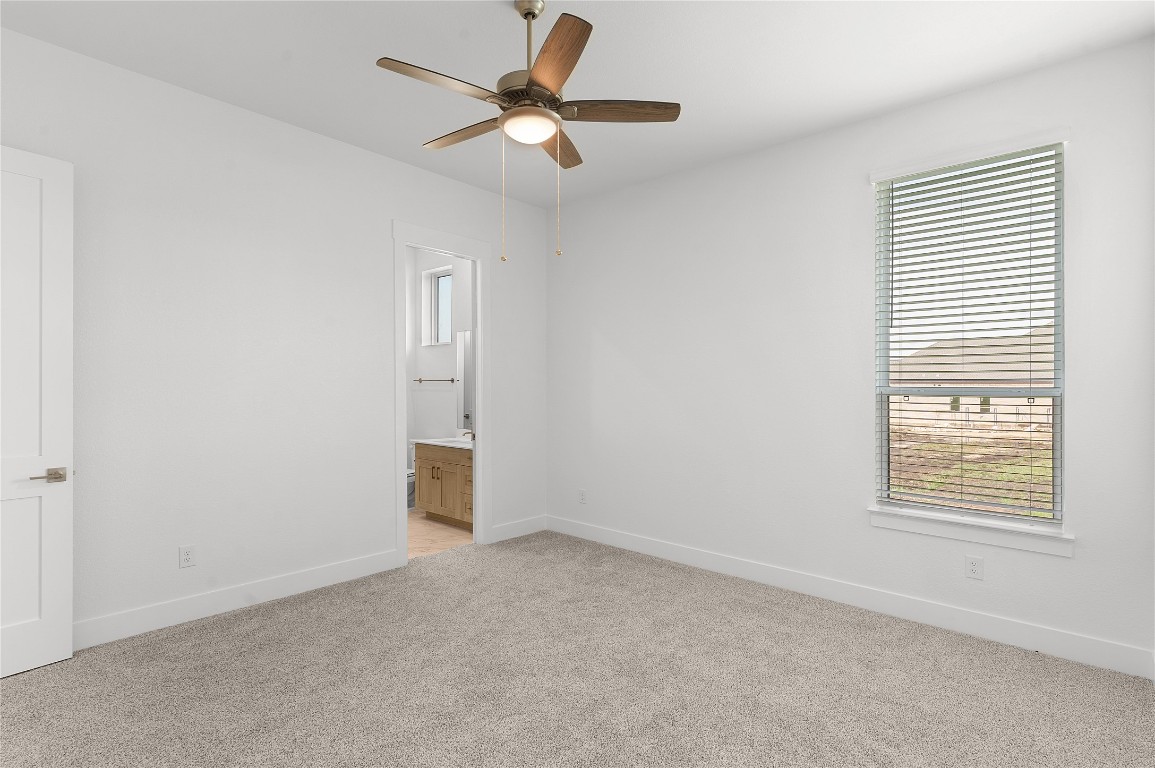 1400 Paxton Lane Georgetown, TX 78633 - Photo 21 of 39 Unfurnished *PHOTO REPRESENTATIVE OF FLOORPLAN ONLY*with ensuite bath, multiple windows, light colored carpet, and ceiling fan