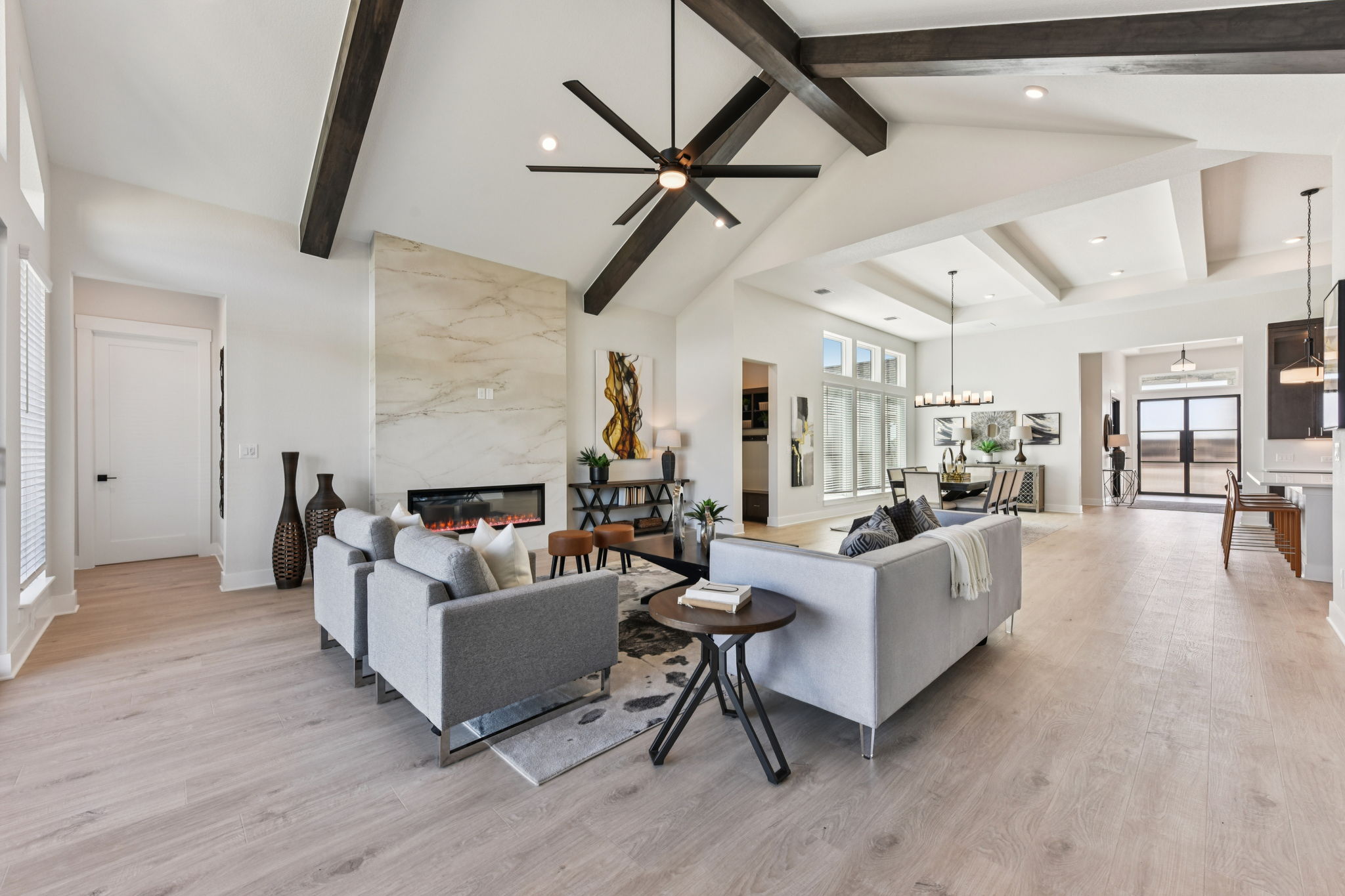 1400 Paxton Lane Georgetown, TX 78633 - Photo 7 of 39 Living room featuring light wood-style floors, a premium fireplace, a ceiling fan, recessed lighting, and vaulted ceiling