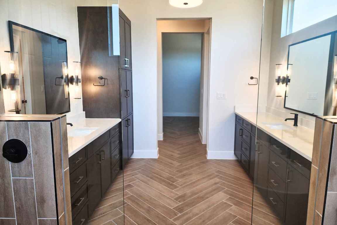 1400 Paxton Lane Georgetown, TX 78633 - Photo 9 of 39 Full bathroom featuring two vanities and baseboards