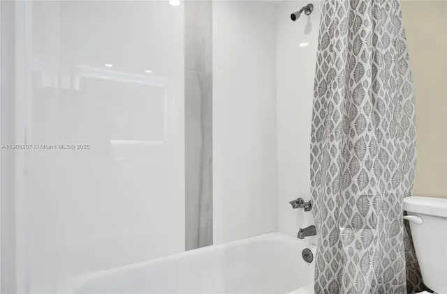 a bathroom with a bathtub and shower
