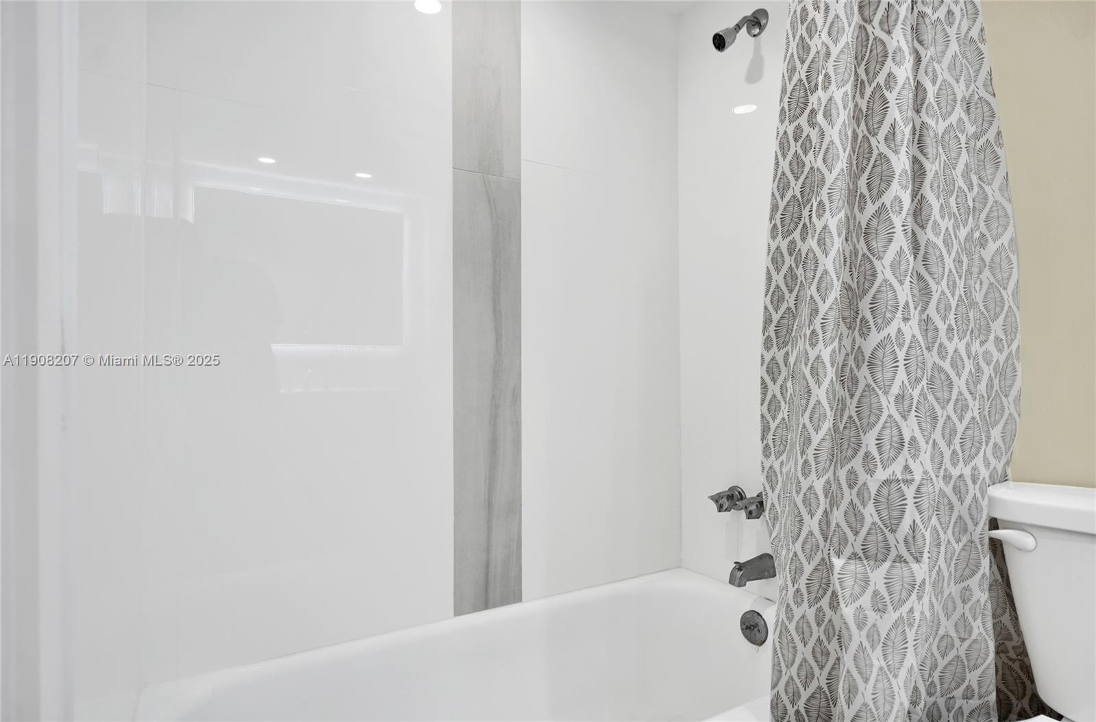 100 Ashbury Road, Unit 103 Hollywood, FL 33024 - Photo 12 of 28 a bathroom with a bathtub and shower