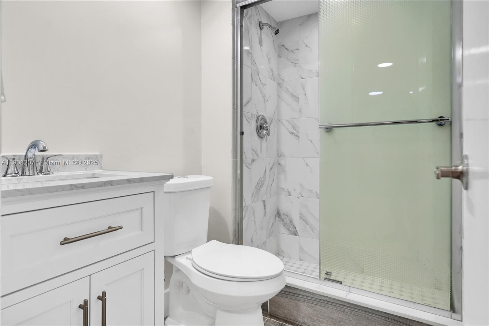 100 Ashbury Road, Unit 103 Hollywood, FL 33024 - Photo 14 of 28 a bathroom with a sink a toilet and shower