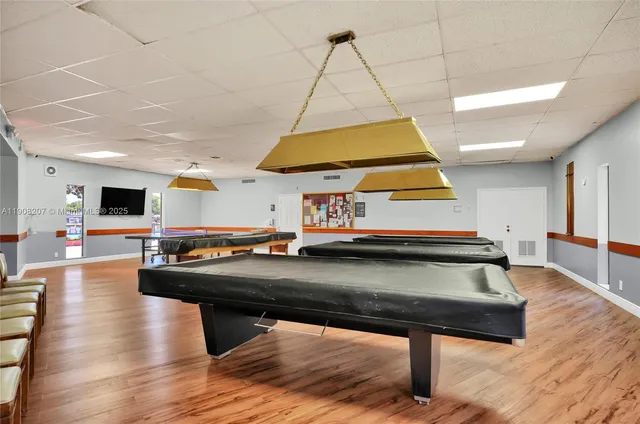 a living room with pool table and a couch