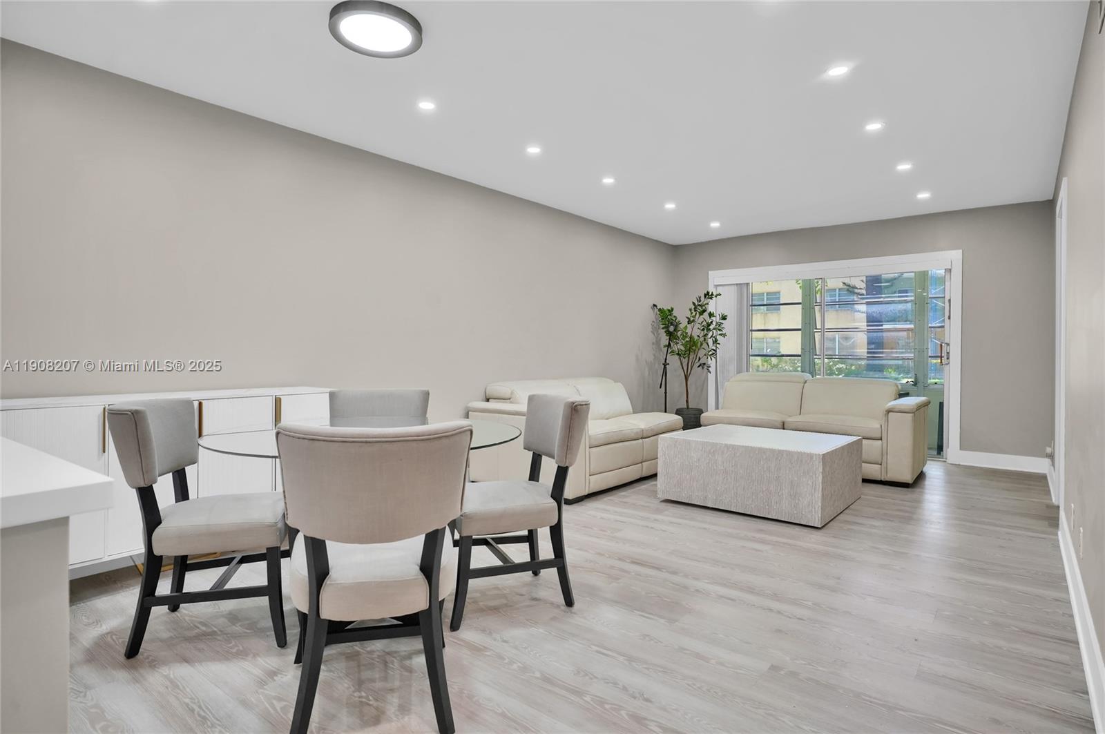 100 Ashbury Road, Unit 103 Hollywood, FL 33024 - Photo 3 of 28 a living room with furniture and a wooden floor