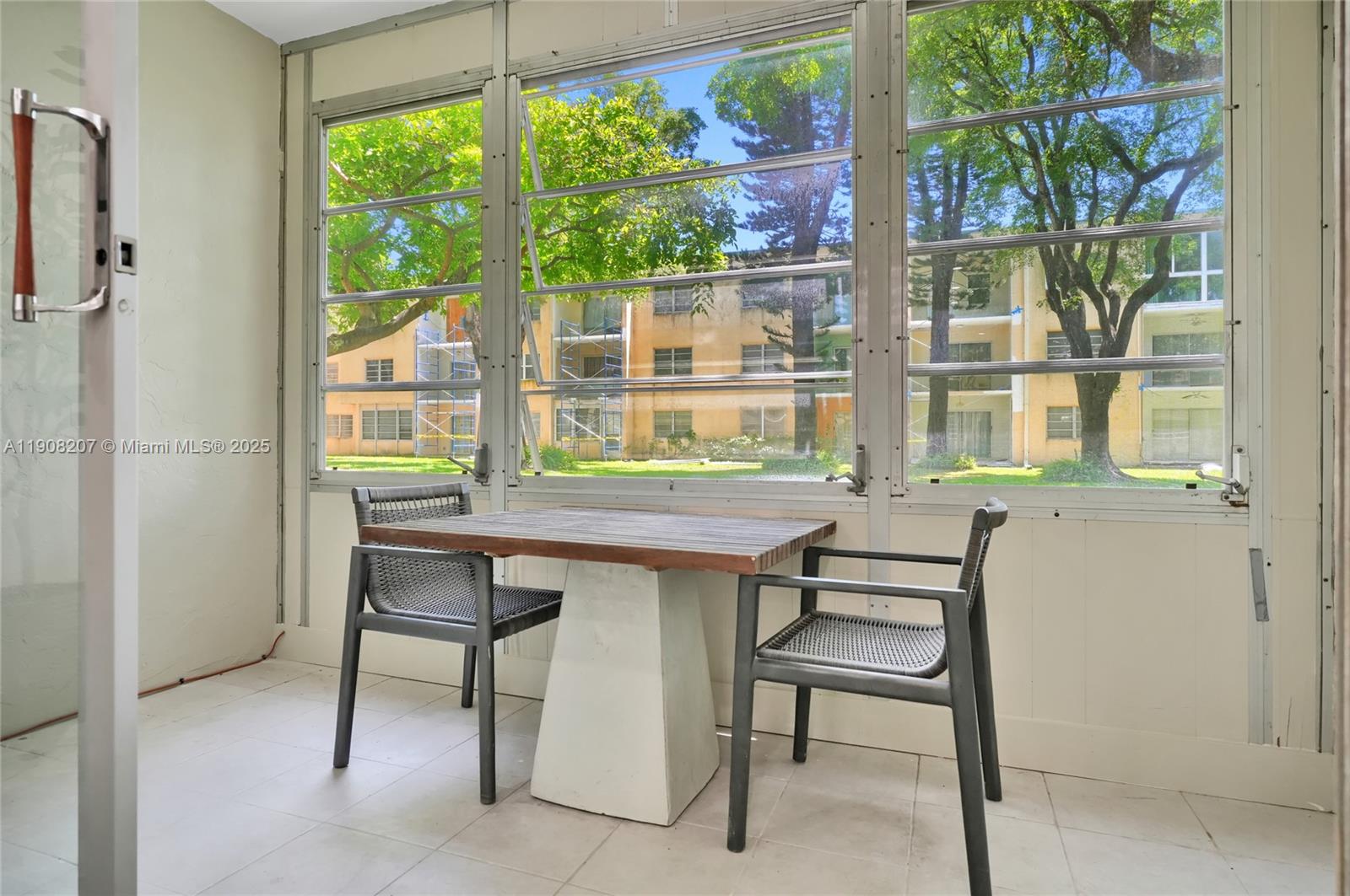 100 Ashbury Road, Unit 103 Hollywood, FL 33024 - Photo 5 of 28 a table room with a wooden floor and furniture