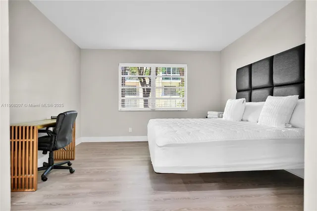 a bed sitting in a bedroom next to a window