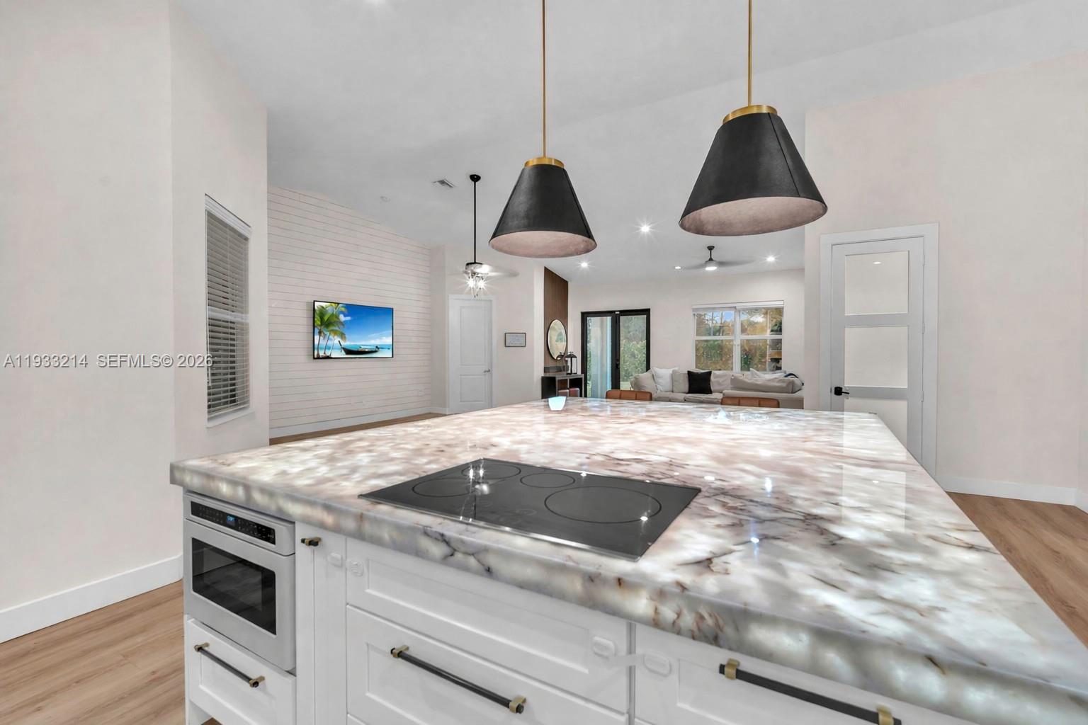 17844 38th Road North Loxahatchee, FL 33470 - Photo 13 of 66 a kitchen with kitchen island a stove a counter space a sink and a stove