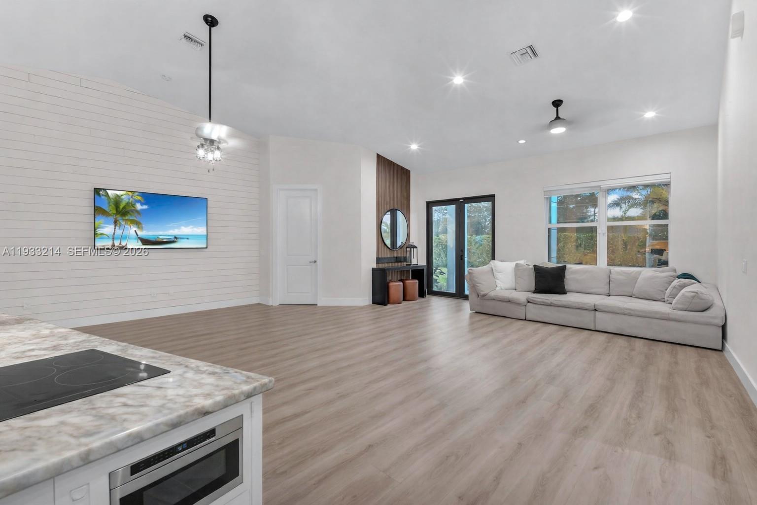 17844 38th Road North Loxahatchee, FL 33470 - Photo 14 of 66 a living room with furniture and a chandelier