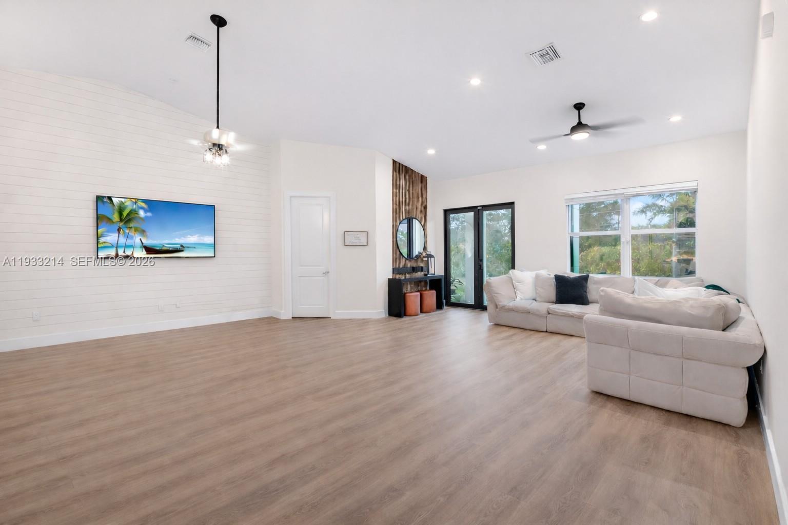 17844 38th Road North Loxahatchee, FL 33470 - Photo 17 of 66 a living room with furniture and a chandelier