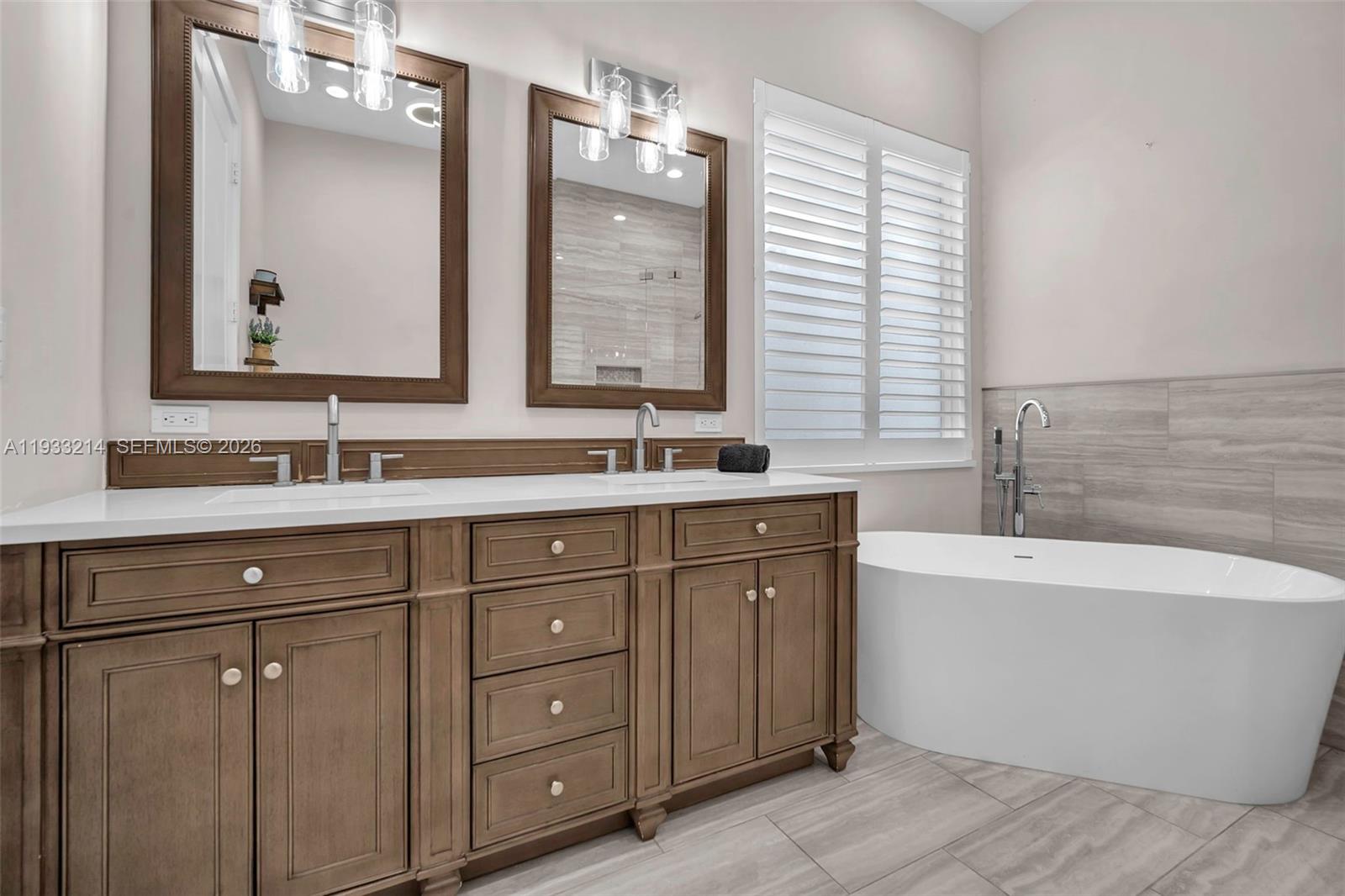 17844 38th Road North Loxahatchee, FL 33470 - Photo 23 of 66 a bathroom with a tub sink and mirror