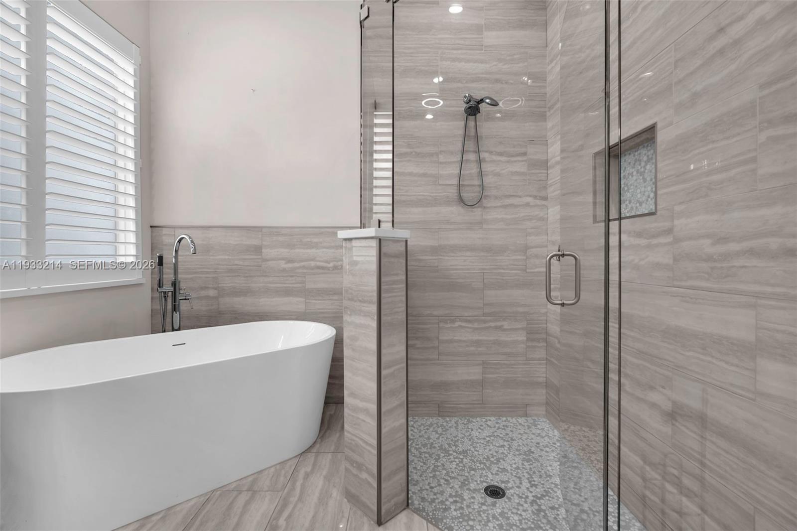 17844 38th Road North Loxahatchee, FL 33470 - Photo 24 of 66 a bathroom with a bathtub and shower