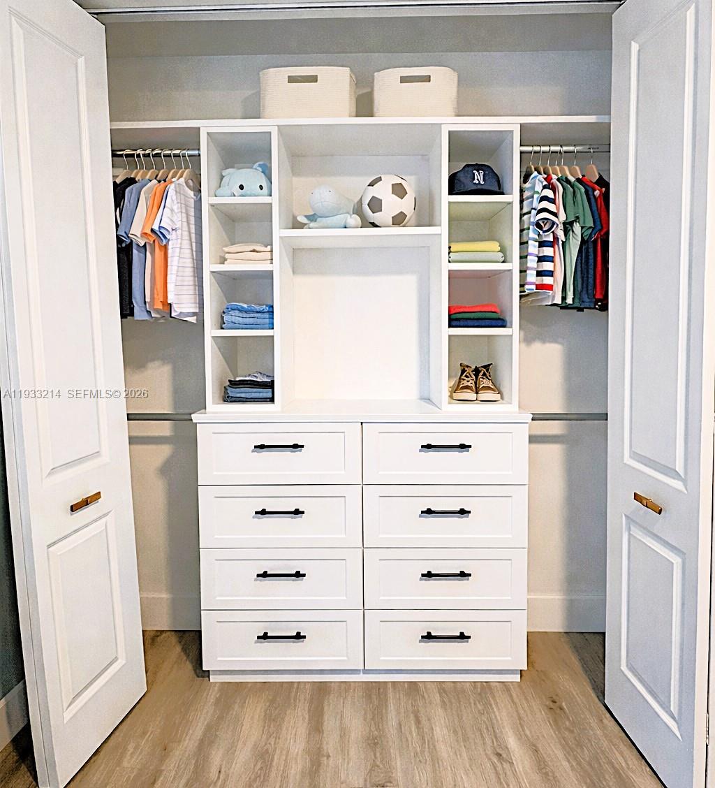 17844 38th Road North Loxahatchee, FL 33470 - Photo 28 of 66 a view of walk in closet with clothes and shoes