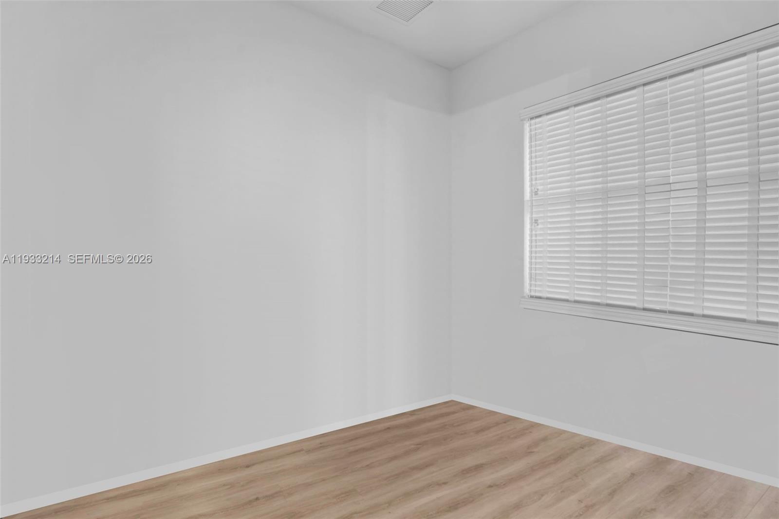 17844 38th Road North Loxahatchee, FL 33470 - Photo 30 of 66 a view of an empty room with wooden floor and a window