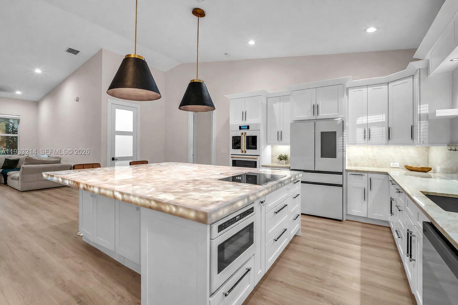 17844 38th Road North Loxahatchee, FL 33470 - Photo 4 of 66 a kitchen with kitchen island granite countertop a large center island and a wooden floors