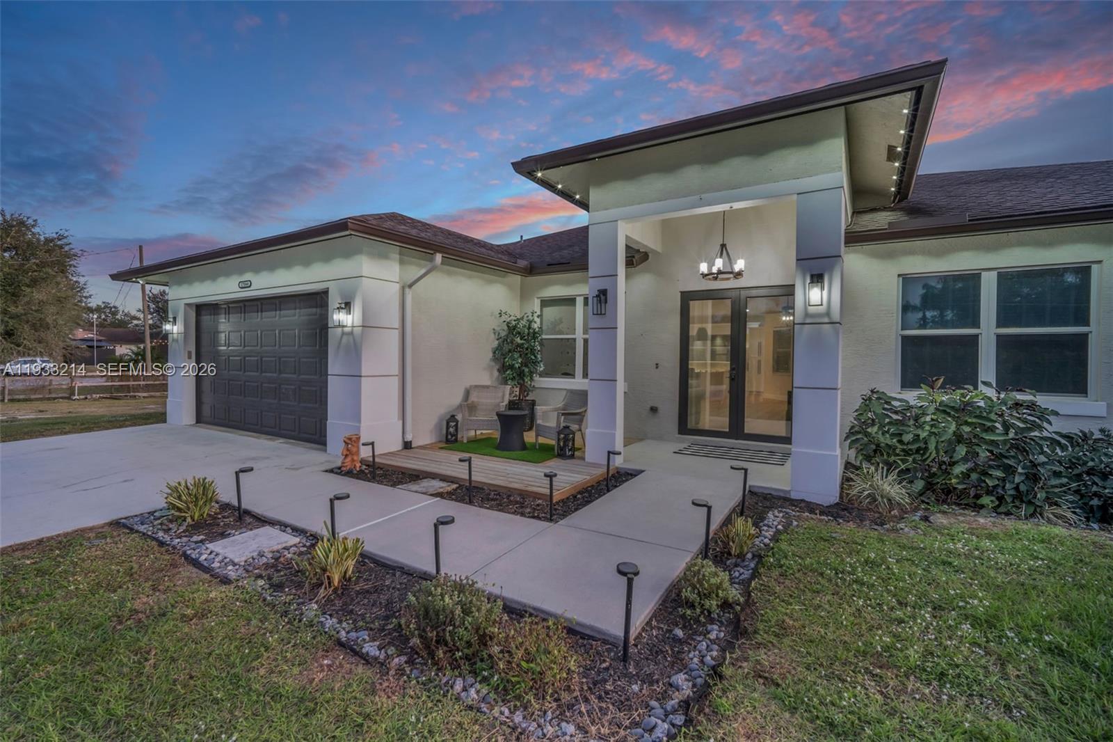 17844 38th Road North Loxahatchee, FL 33470 - Photo 54 of 66 a front view of a house with garden