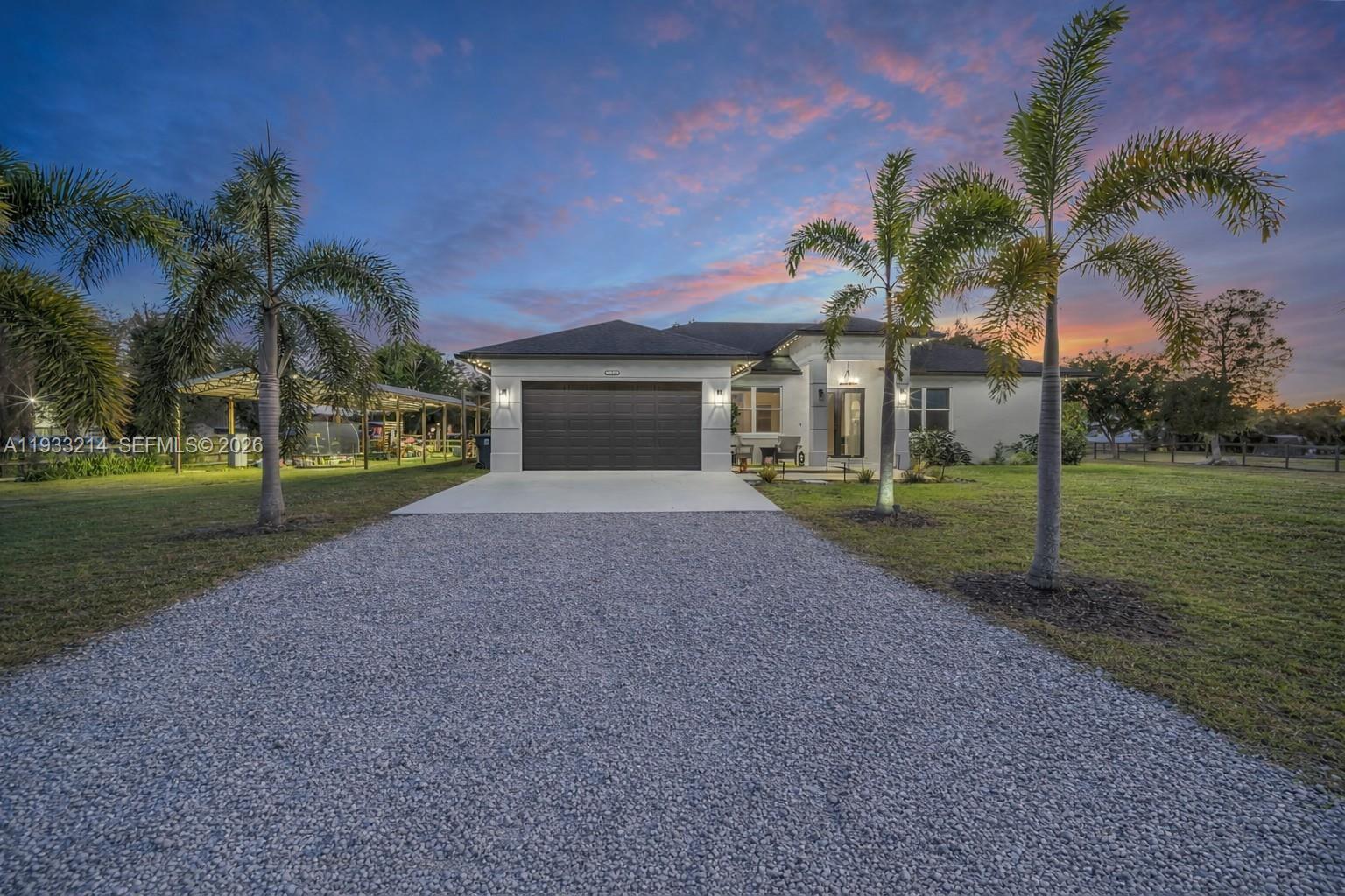 17844 38th Road North Loxahatchee, FL 33470 - Photo 55 of 66 a view of a house with a yard and palm trees