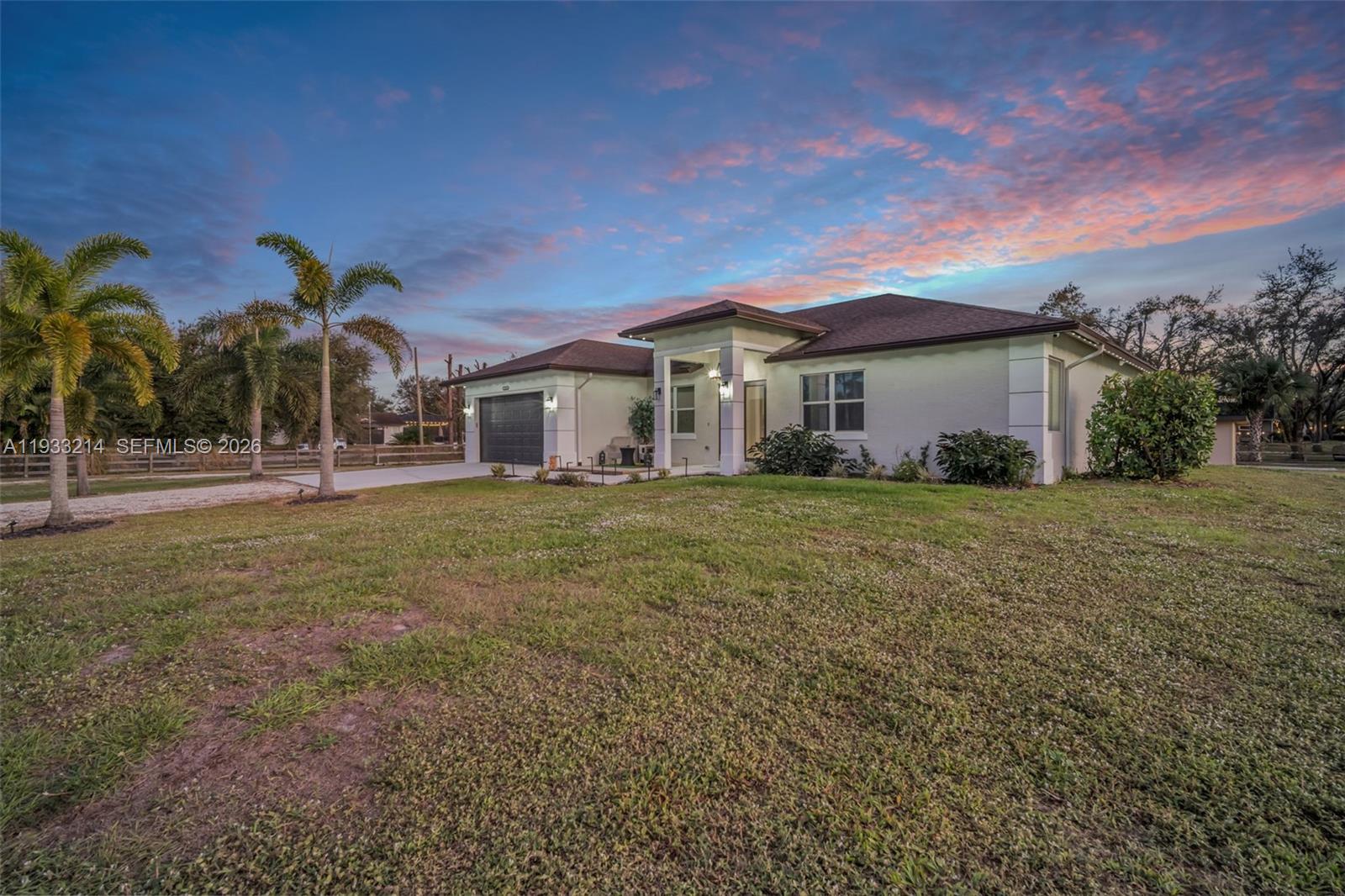 17844 38th Road North Loxahatchee, FL 33470 - Photo 57 of 66 a front view of house with yard and green space