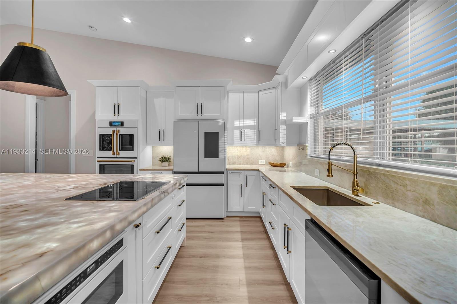 17844 38th Road North Loxahatchee, FL 33470 - Photo 6 of 66 a large kitchen with stainless steel appliances granite countertop a sink and dishwasher a stove top oven with wooden floor