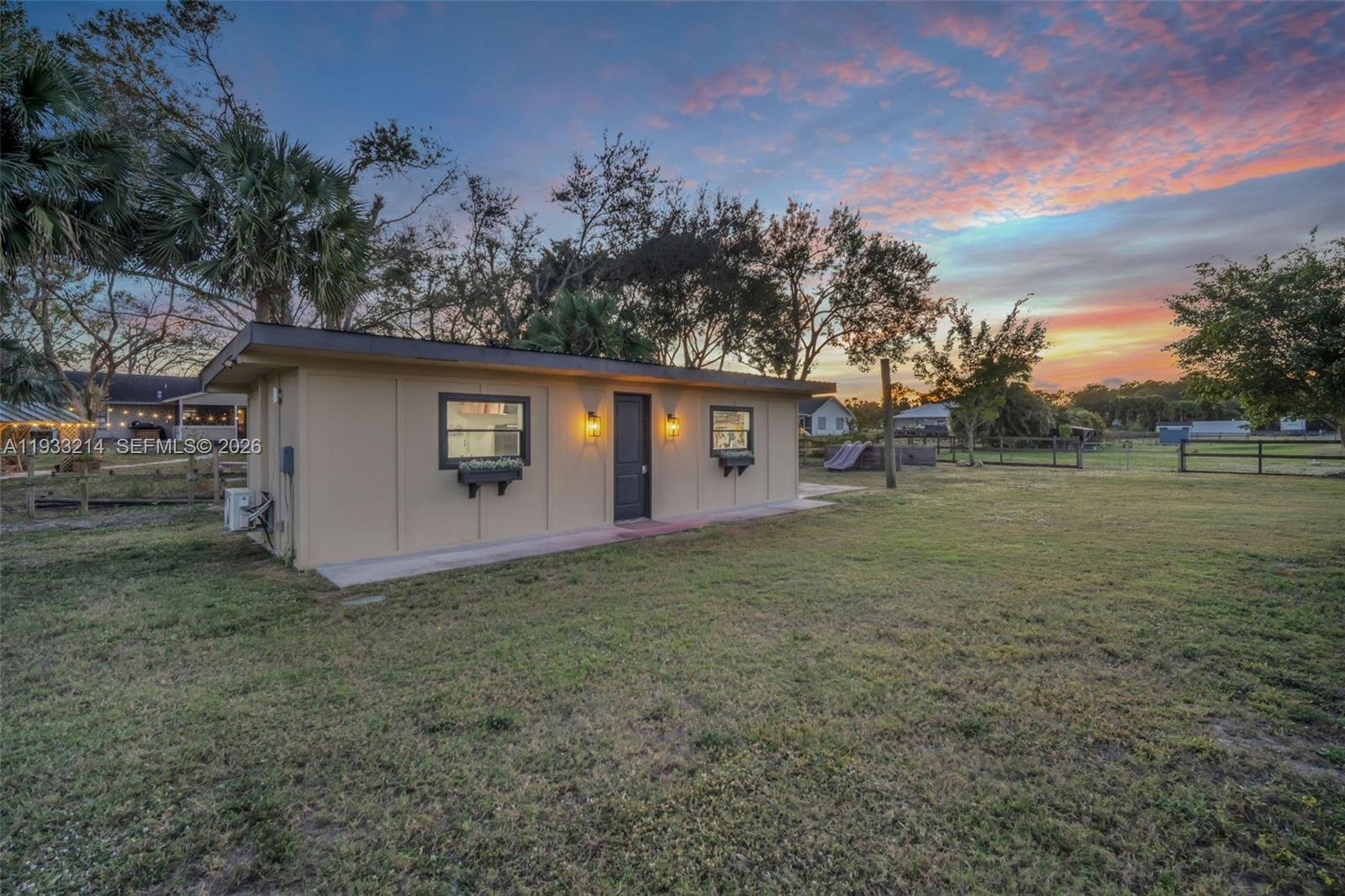 17844 38th Road North Loxahatchee, FL 33470 - Photo 62 of 66 a view of a house with backyard and trees