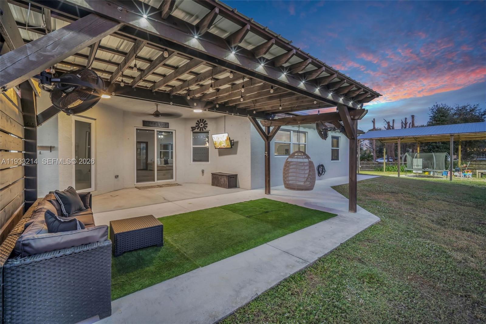 17844 38th Road North Loxahatchee, FL 33470 - Photo 66 of 66 a view of a porch with couches chairs and a yard