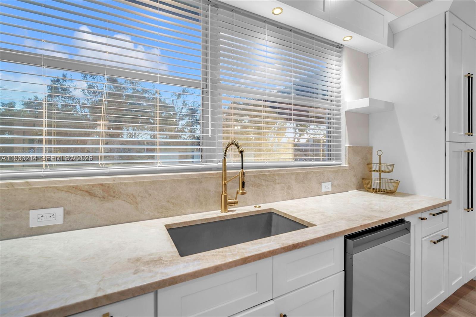 17844 38th Road North Loxahatchee, FL 33470 - Photo 7 of 66 a view of a kitchen counter a sink and wooden cabinets