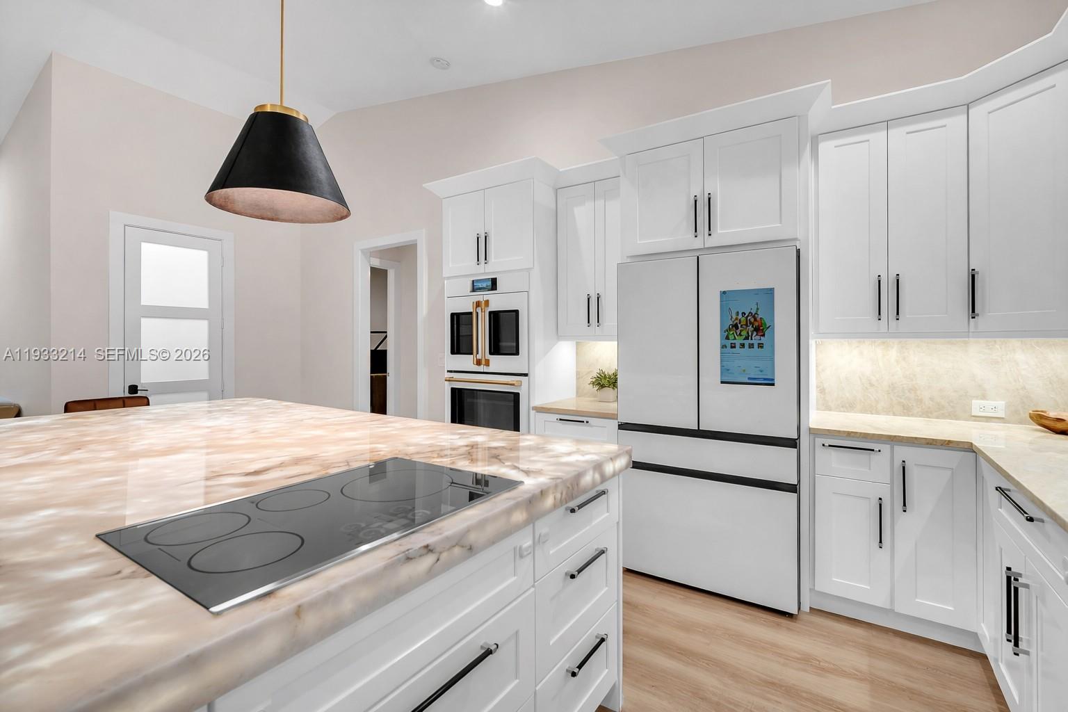 17844 38th Road North Loxahatchee, FL 33470 - Photo 8 of 66 a kitchen with stainless steel appliances granite countertop a sink stove and refrigerator