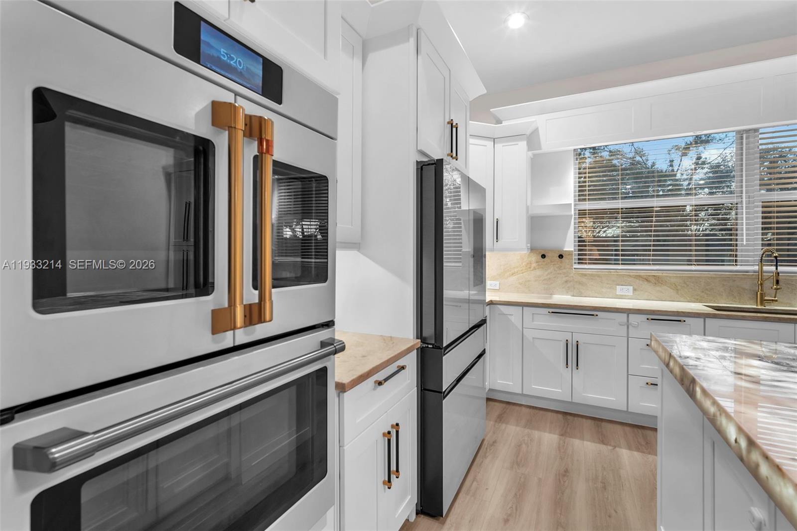 17844 38th Road North Loxahatchee, FL 33470 - Photo 9 of 66 a kitchen with granite countertop white cabinets and stainless steel appliances