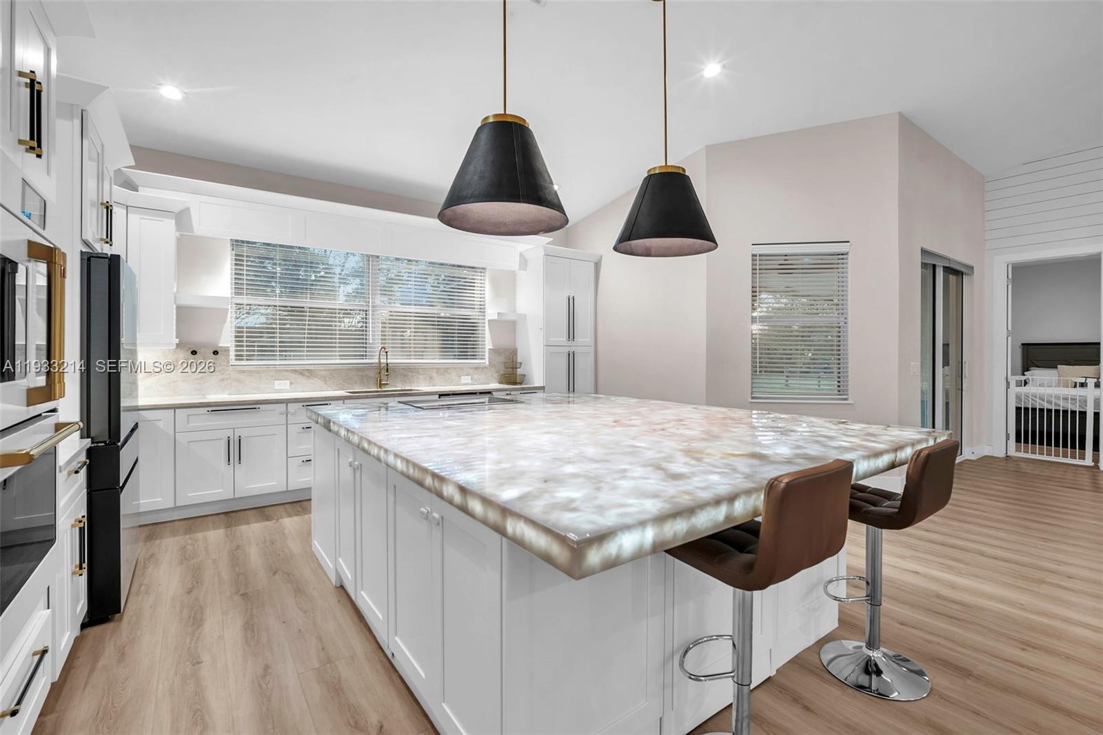 17844 38th Road North Loxahatchee, FL 33470 - Photo 10 of 66 a kitchen with stainless steel appliances granite countertop a sink a stove and a wooden floors