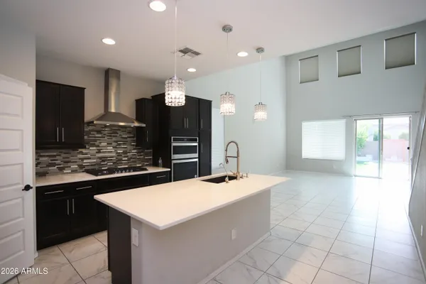 a kitchen with stainless steel appliances kitchen island granite countertop a sink and cabinets