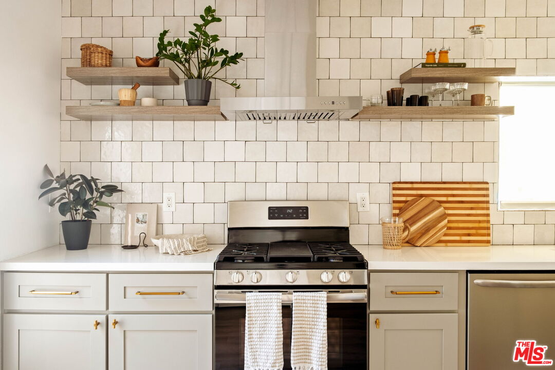 2831 South Corning Street Los Angeles, CA 90034 - Photo 16 of 41 a kitchen with a stove and cabinets