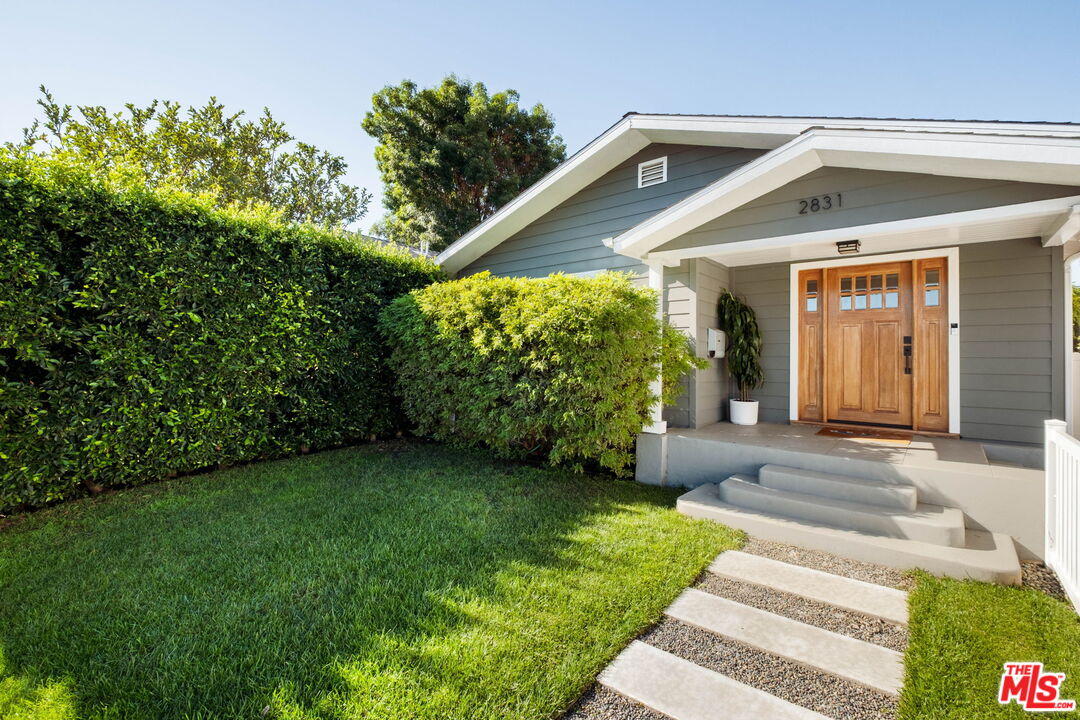 2831 South Corning Street Los Angeles, CA 90034 - Photo 2 of 41 a front view of a house with garden