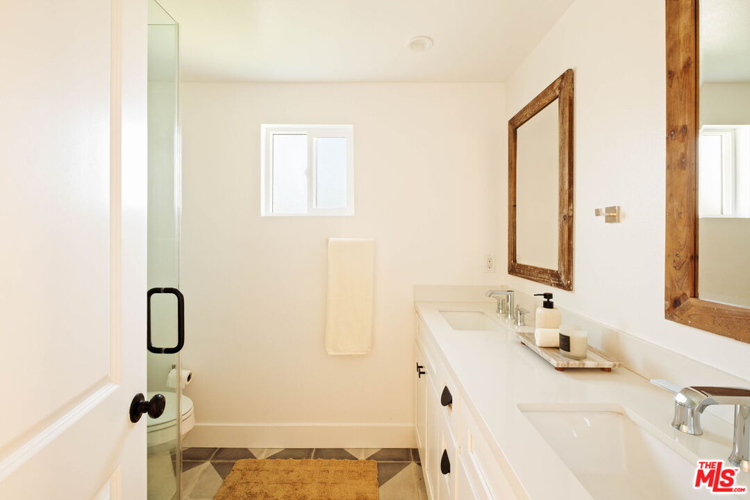 2831 South Corning Street Los Angeles, CA 90034 - Photo 24 of 41 a bathroom with a sink and a mirror