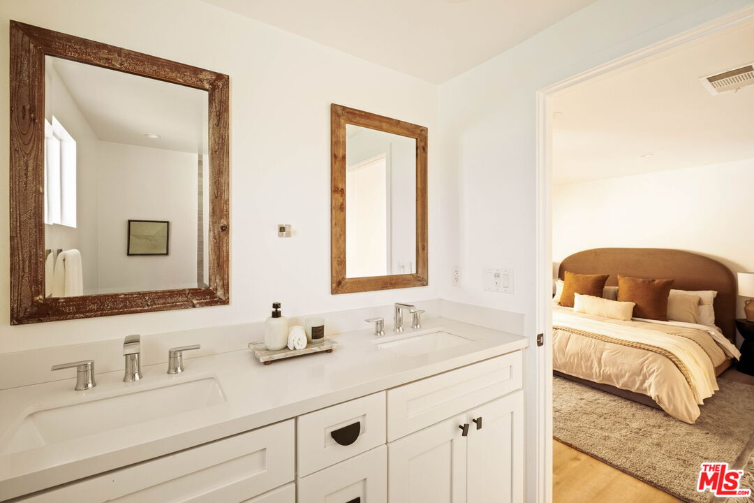 2831 South Corning Street Los Angeles, CA 90034 - Photo 25 of 41 a bathroom with 2 sink and a mirror
