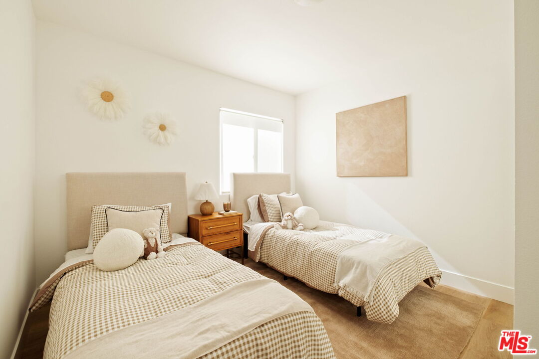 2831 South Corning Street Los Angeles, CA 90034 - Photo 27 of 41 a bedroom with two beds and painting on the wall