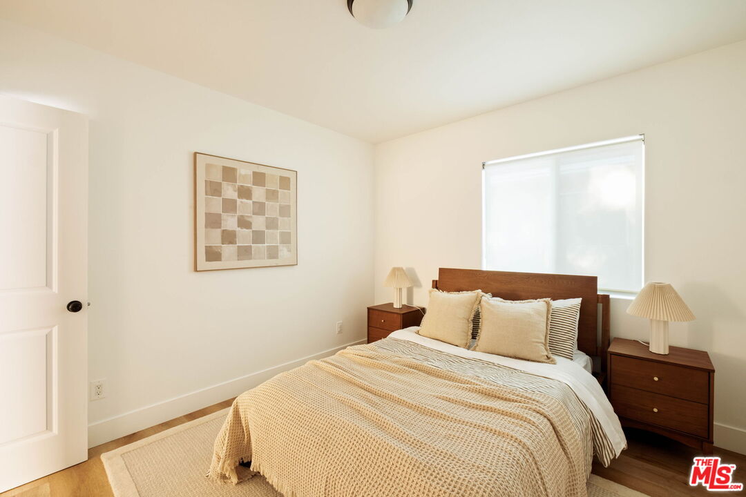 2831 South Corning Street Los Angeles, CA 90034 - Photo 29 of 41 a bedroom with a bed and a window
