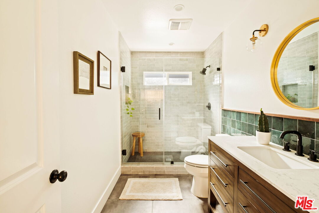 2831 South Corning Street Los Angeles, CA 90034 - Photo 30 of 41 a bathroom with a sink a toilet and shower
