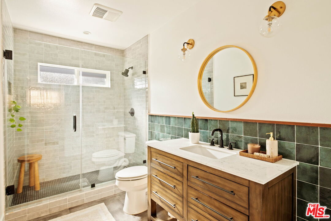 2831 South Corning Street Los Angeles, CA 90034 - Photo 31 of 41 a bathroom with a toilet a sink and a mirror