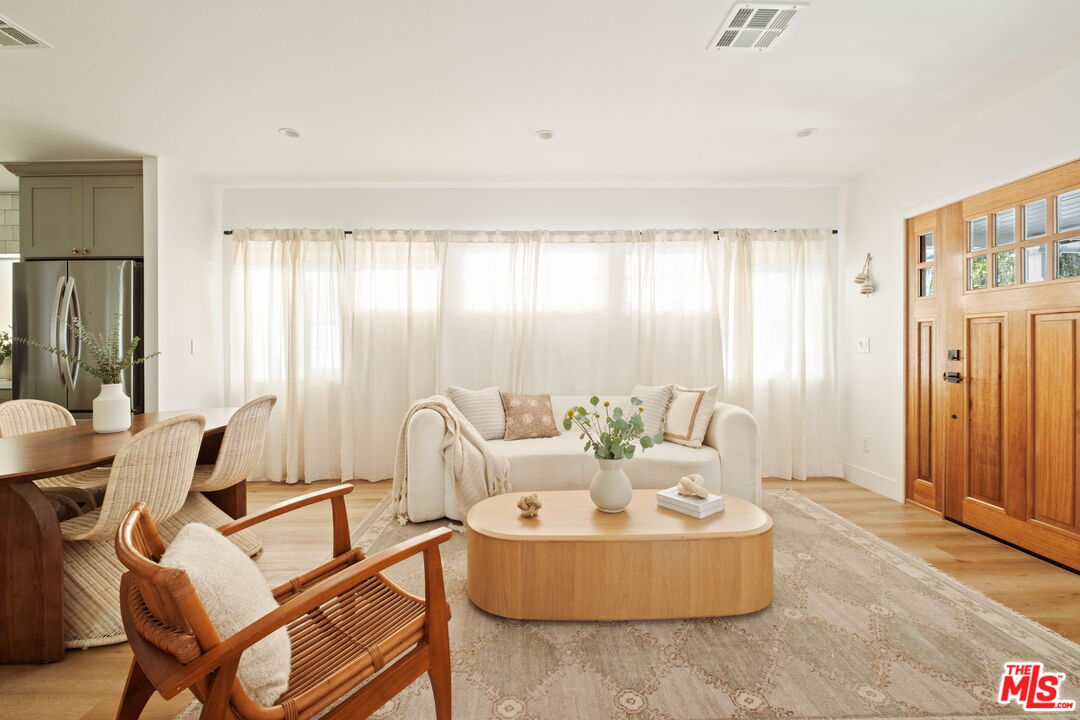 2831 South Corning Street Los Angeles, CA 90034 - Photo 7 of 41 a living room with furniture and a large window